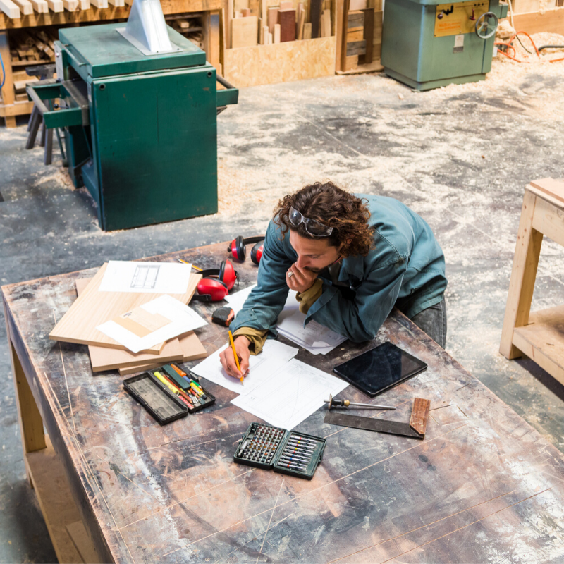 Man standing over a workbench